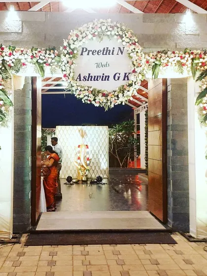 A straight-on view of the floral entrance arch, showcasing its fullness and the elegant welcome sign. This type of entrance makes a statement and is perfect for formal wedding celebrations.