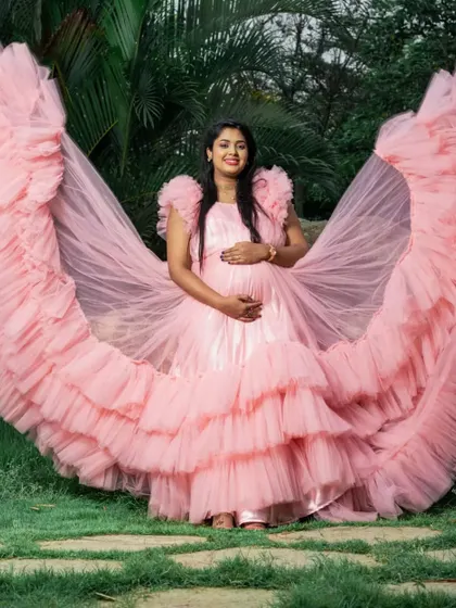 Celebrating motherhood should be glamorous. This dramatic pink ruffled gown is part of my rental collection for maternity photoshoots, designed to make expectant mothers feel beautiful and celebrated.