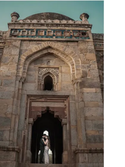 A powerful silhouette of a couple embracing within the grand entrance of a monument. This artistic shot uses the architecture to frame their connection in a dramatic and memorable way.