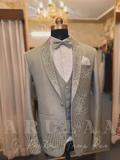 A unique take on a groom's reception suit in a beautiful sage green. I designed this with a peacock-inspired motif, using tonal and silver beadwork to create the texture of feathers on the lapel and cuff.