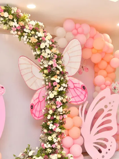 A close-up of a butterfly-themed decoration, showing the large pink butterfly wings and floral arch detail. This highlights the craftsmanship and attention to detail I put into my work.