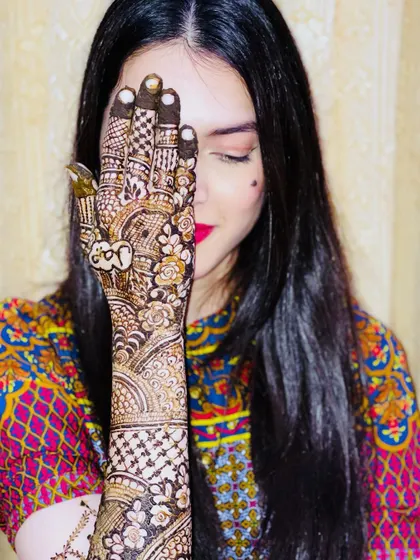 Another angle of the bride, showing the detailed work on her hand and her happy expression.