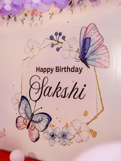 A close-up of the custom-printed backdrop for Sakshi's butterfly-themed birthday.