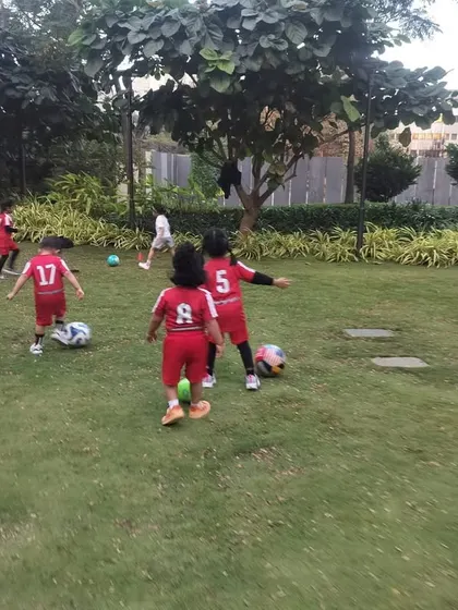 From the back, you can see the team jerseys with numbers, making the kids feel like professional players. This simple touch adds to the excitement and sense of belonging in our toddler football classes.