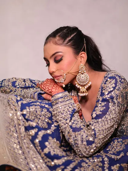 A portrait in the royal blue lehenga, showing a soft and romantic moment.