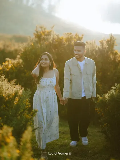 Walking hand-in-hand through a field at sunset, this image captures the warmth and romance of a pre-wedding adventure.
