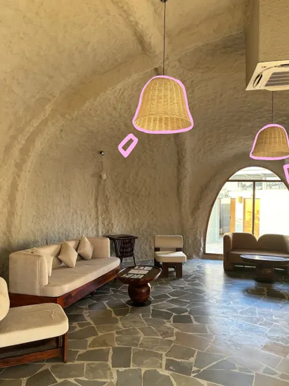 The unique cave-like architecture of our stay in Jawai, with the lamps highlighted by a simple pink outline.