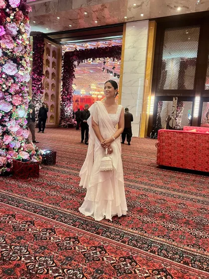 The scale of the Ambani wedding decor was breathtaking. My simple yet elegant all-white ruffled saree stood out beautifully against the opulent floral arrangements and grand carpets.