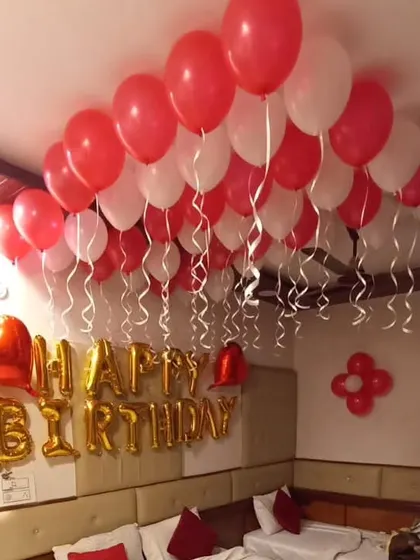 The red and white color scheme is perfect for creating a vibrant and romantic birthday surprise.