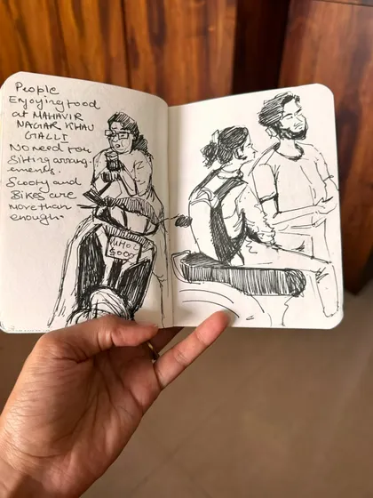 A pen and ink sketch capturing people enjoying street food in Mahavir Nagar. Sometimes a scooter is all the seating you need in Mumbai!
