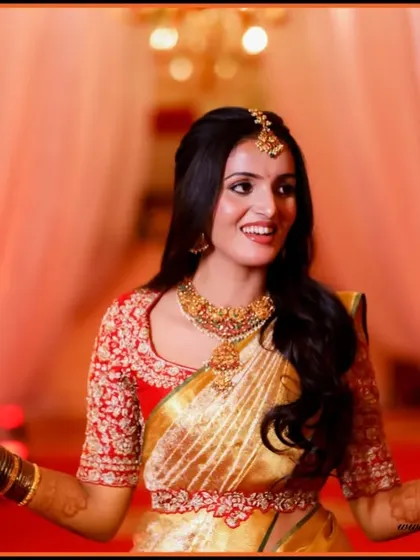 A stunning bridal entry photo. The bride's joyful expression and open arms create a welcoming and vibrant portrait, full of life and color.