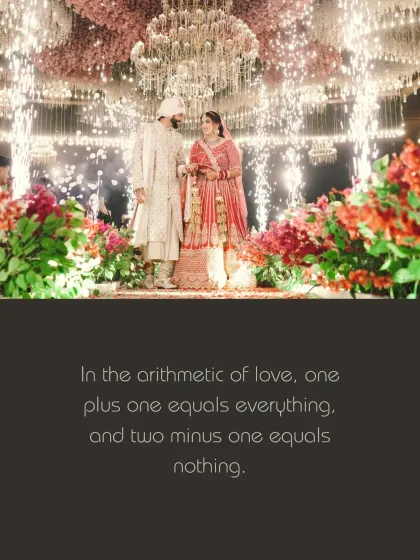 The couple stands amidst a shower of sparklers and a grand floral chandelier. This wide shot captures the scale and opulence of the celebration.