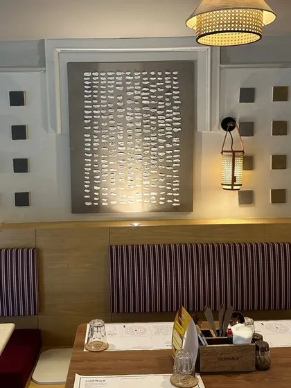 Another view of the textured art wall at Sidewalk, Agra.