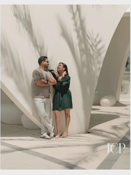 Using light and shadows from palm trees in Dubai to create an artistic and intimate couple portrait.