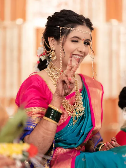 A fun and playful moment! This bride shows her personality while still looking every bit the traditional South Indian queen.