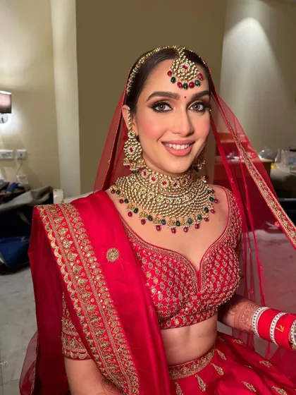 The bride's happy and radiant expression says it all. The makeup is designed to make her feel confident and beautiful on her special day.
