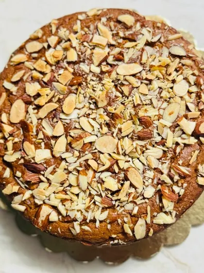 This is my whole wheat jaggery almond cake, a wonderfully nutty and wholesome tea cake. It's topped with a generous layer of sliced almonds for a beautiful look and crunchy texture.