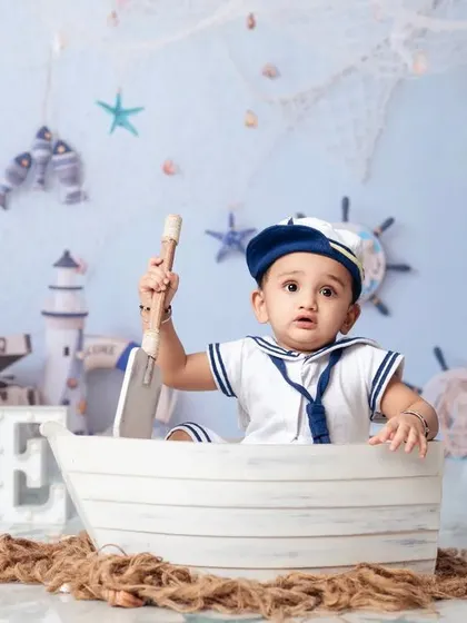 Captain of his own ship! A cute portrait of a one-year-old exploring our nautical props.