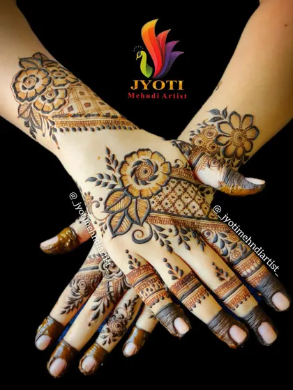 This is a perfect example of an elegant floral design suitable for a bride, bridesmaid, or wedding guest. The composition flows beautifully across both hands, combining bold flowers with delicate, detailed patterns.
