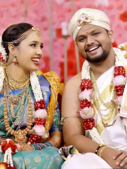 A joyful, candid moment between the bride and groom, capturing genuine laughter during their wedding celebration.