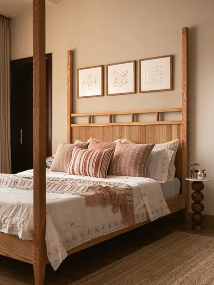 In this master suite, a custom four-poster bed with a fluted headboard takes center stage. The design is a study in linear details, from the bed frame to the patterns in the artwork above.