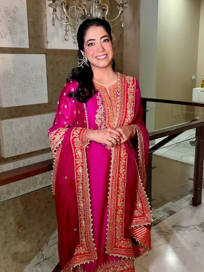 A full-length view of Tanisha's gorgeous Roka outfit and her glowing makeup.
