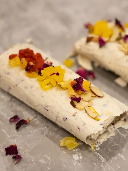 A pristine shot of our Mishti Malai, showcasing the delicate roll and colourful toppings. This signature dessert is a modern twist on traditional Indian flavours.