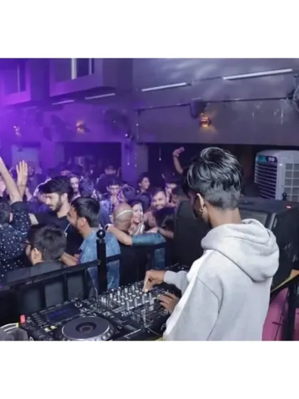 The crowd right up against the console, fully immersed in the music. I love being this close to the energy of the party.