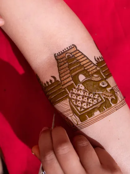 A close-up of the Tamil Nadu temple and elephant motif being created. The precision in each line ensures a clean and impactful final design.