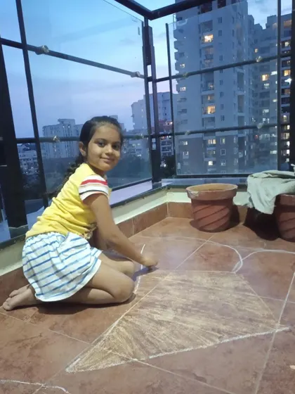 A student uses chalk to create a large-scale drawing on her balcony. I encourage children to think of the world as their canvas and to express their creativity wherever they are.