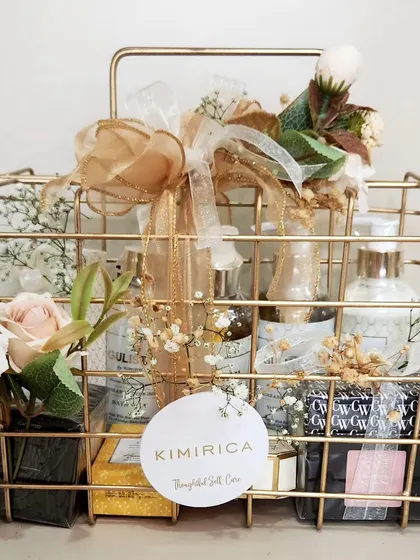 This elegant gold wire basket is filled with Kimirica's "Gulen" collection, accented with white and gold florals for a sophisticated display.