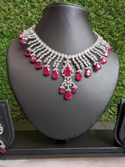 This simple AD necklace with ruby stones and strawberry beads is a perfect, elegant set that complements modern sarees and dresses.