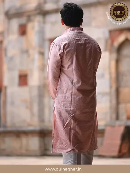 A back view of a model in a pink kurta, set against a heritage backdrop. This shows how my outfits are designed to look good from every angle.