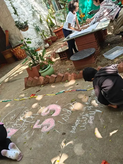 This is how we explore mathematics. Some children transcribe a mammoth 59-sided polygon with chalk on the ground, while others work on finding patterns with cubes. For us, math is not confined to books; it is a language we find in the world around us, full of patterns, odd shapes, and joyful discovery.