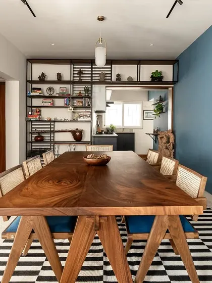 For us, a home is a place for connection. This solid wood dining table, intentionally placed at the heart of a renovated house, serves as a testament to that belief. It’s a space designed not just for meals, but for conversations, laughter, and the creation of memories, surrounded by the client's personal collection of art and travel artifacts.