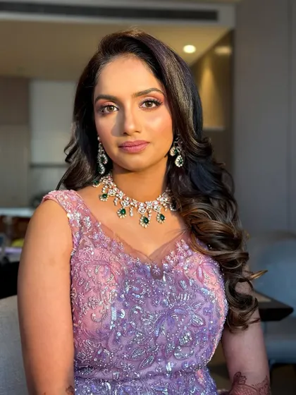 A dreamy reception look in a lilac gown, with soft pink and purple tones on the eyes.