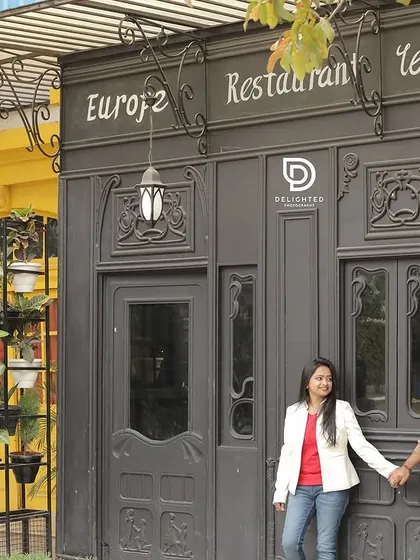 This pre-wedding location offered a variety of backdrops, including this charming European-style restaurant facade. It allows for diverse looks all in one shoot.