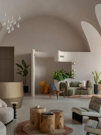 This angle highlights the contrast between the smooth, plastered vaults and the textured, natural materials of the furniture and rugs.