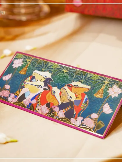 This is a money envelope or 'shagun' envelope from the Pichwai collection. Even the smallest details of a wedding should carry the theme, and this piece ensures a cohesive and elegant gifting experience.