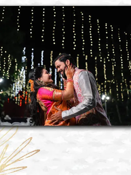 A magical moment under a canopy of fairy lights. This engagement photo captures the couple sharing a dance, creating a dreamy and romantic atmosphere.