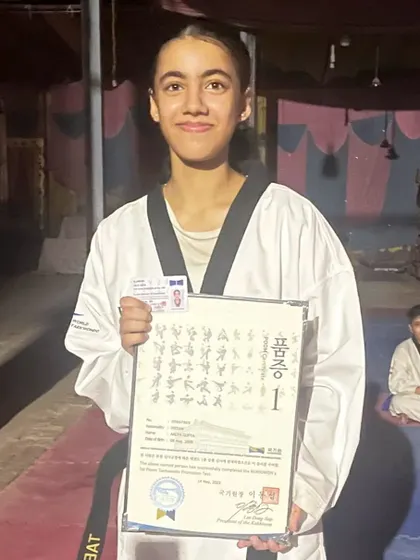 Aalya Gupta with her official black belt certificate. We are proud to welcome her to our black belt squad.