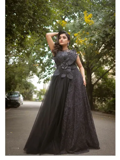 For a touch of dark romance, this black evening gown is an absolute showstopper. Its intricate design and flowing silhouette are perfect for creating dramatic and high-fashion pre-wedding photos.
