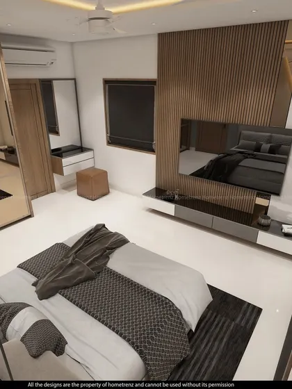 A guest bedroom with a unique geometric-patterned accent wall. The mirrored wardrobe and clean lines make the space feel modern and spacious.