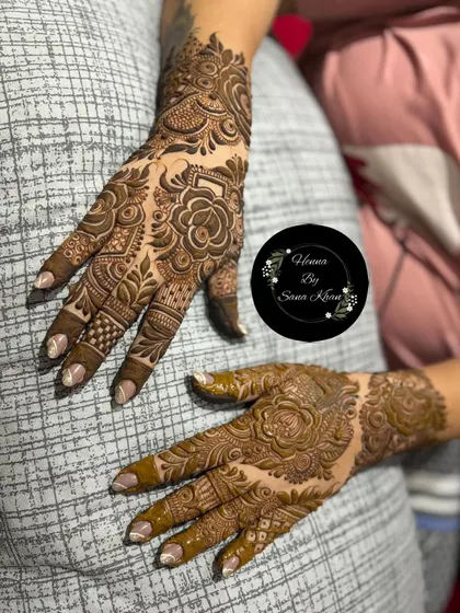 A close-up of a bold floral design, showing the detail in the rose petals and surrounding leafy patterns. The shading technique brings the flowers to life.