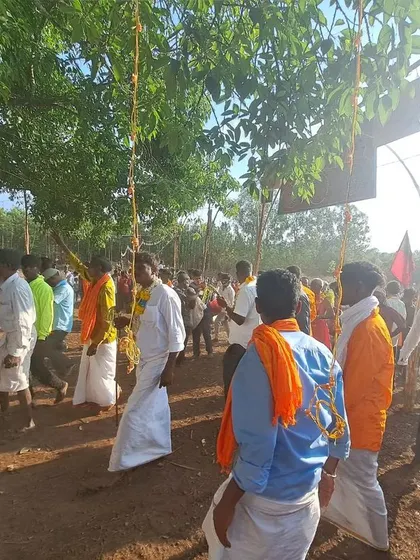 The procession moving along, with everyone walking barefoot, deeply connected to the soil.
