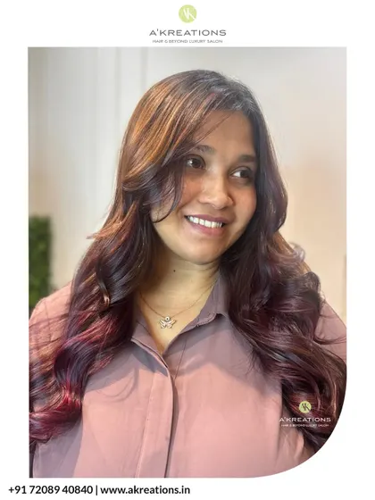 Our happy client showing off her new balayage, with face-framing layers and a beautiful blend of natural and red tones.