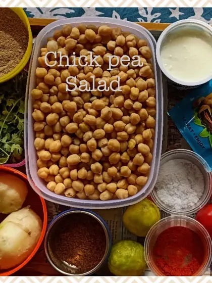 A colorful spread of ingredients for our healthy chickpea salad. We use fresh vegetables, boiled chickpeas, and simple spices to create a nutritious and tasty dish.