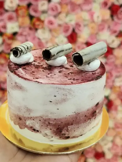 A mini cake with a fruity twist. This is my mini blueberry cake, with a beautiful marbled frosting and delicate chocolate curls on top. It's a light and refreshing option for a small, sweet treat.