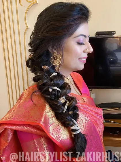 A side-swept bubble braid with pearl and thread accessories. This is a soft and romantic style, perfect for a daytime wedding or engagement.