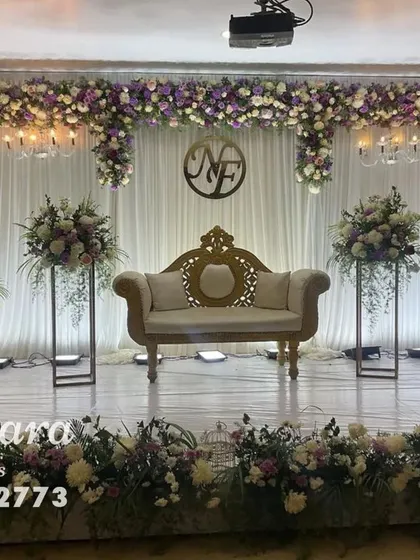 A beautiful and balanced stage design for an engagement or reception. We used a soft color palette of lavender and white florals, paired with modern stands and elegant chandeliers for a sophisticated feel.